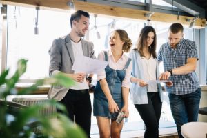 cheerful-colleagues-discussing-work-plans-during-break_23-2147707749