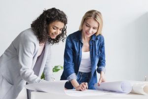 multiracial-smiling-employees-working-with-papers_23-2148180719