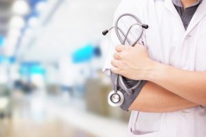 doctor-with-stethoscope-hands-hospital-background_1423-1