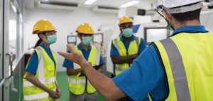 Factory workers meeting before work And put on a mask